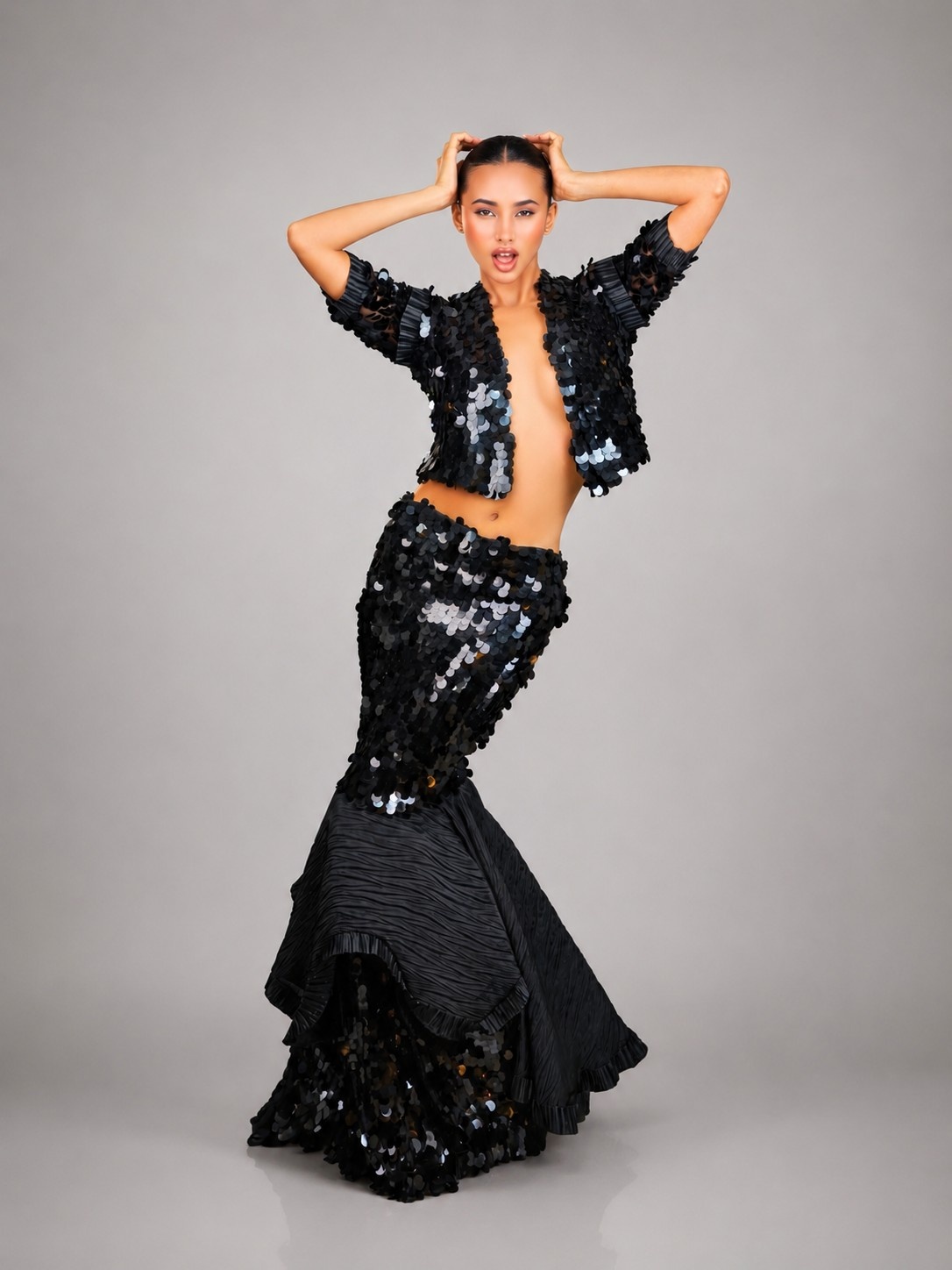 Model wearing the Midnight Muse look with hands lifted above her head
